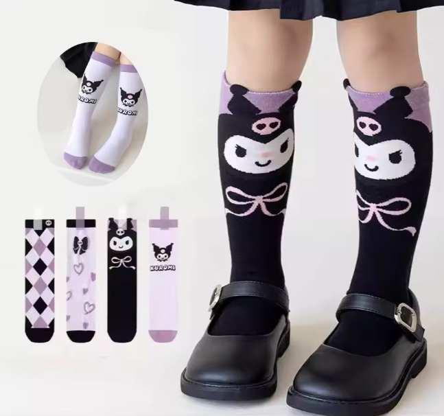 Black knee-high socks with cartoon face design worn by a person, with additional sock designs shown.